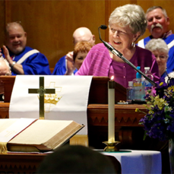 Woman speaking at a church service.