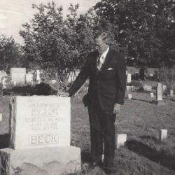 Man visiting grave in a cemetery.